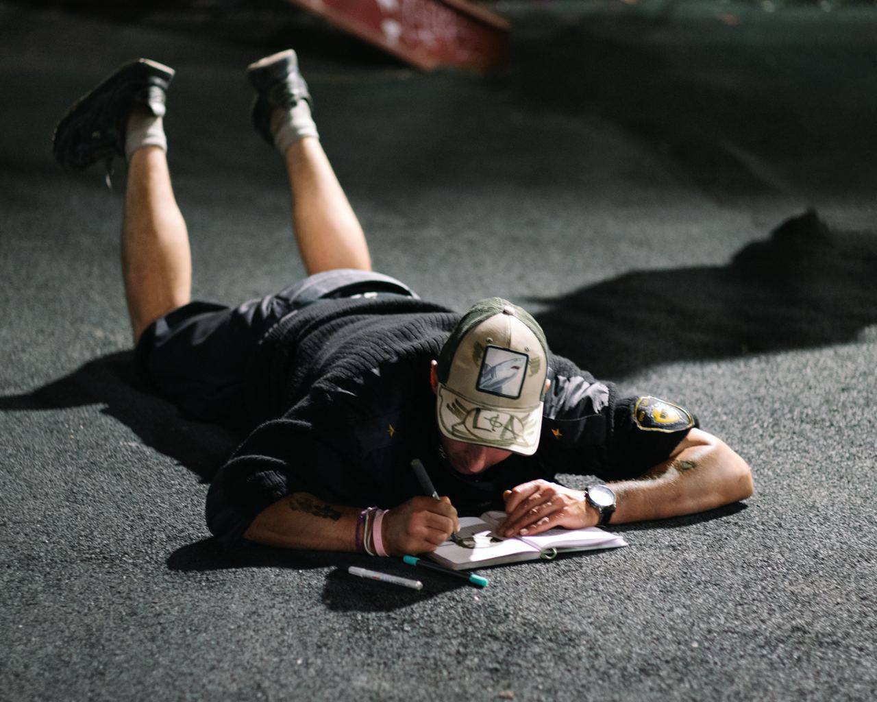 A teenager lies on the floor writing in a notebook—a symbol of growing up and the important questions of adolescence