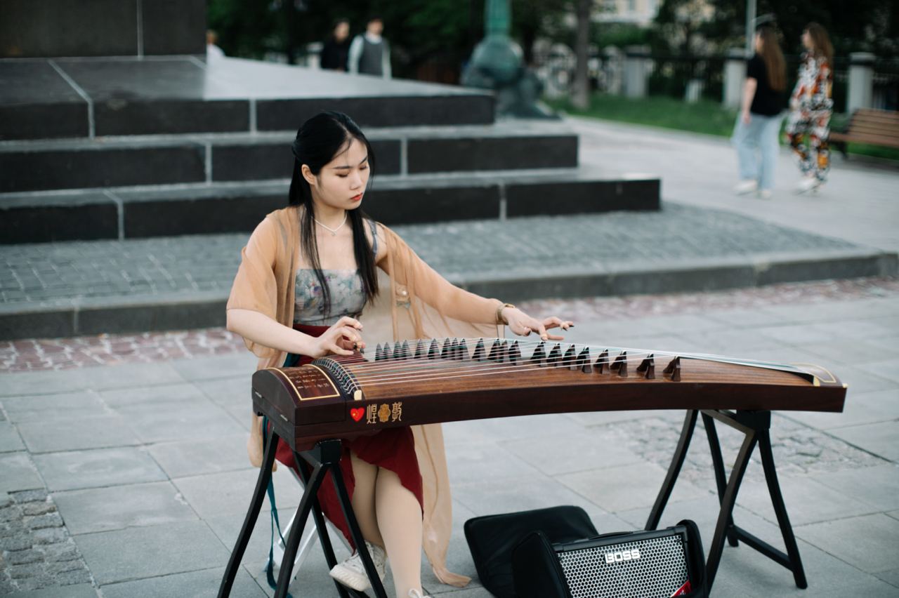 Woman playing a traditional musical instrument outdoors - a symbol of emotional balance and coping with seasonal affective disorder (SAD)
