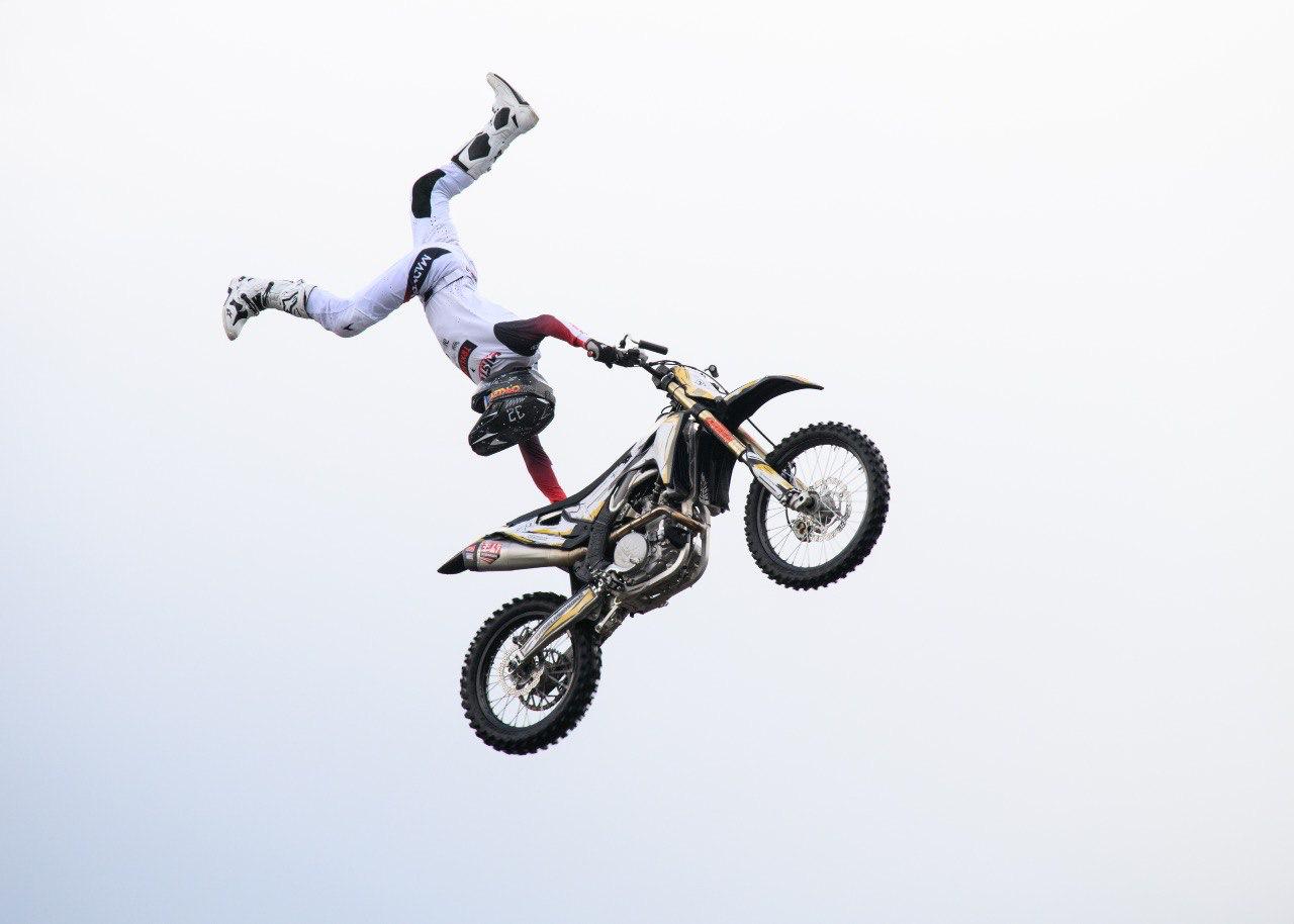Motocross rider performing an aerial stunt, symbolizing the impact of sleep on reaction, focus, and coordination